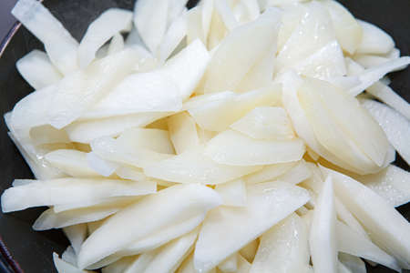 Raw sliced fresh potatoes for french friesの写真素材