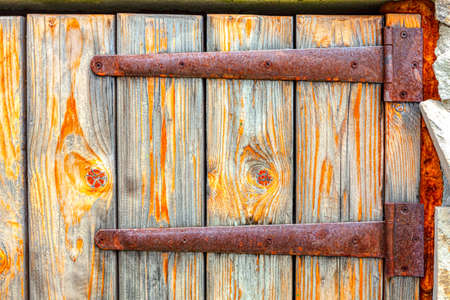 Rusty hinges of the wooden gateの写真素材