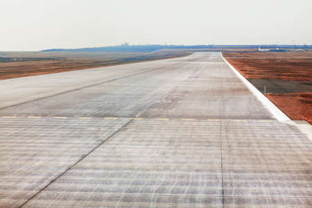Airport Runway . Hard ground along which aircraft take off and landの写真素材