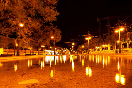 Night city after torrential rain . Flood on the illuminated street