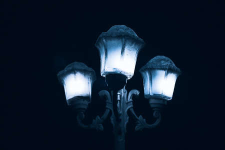 Retro street light in the dark night . Vintage lamp postの写真素材