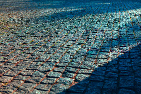 Granite pavement surface . Cobblestone road background