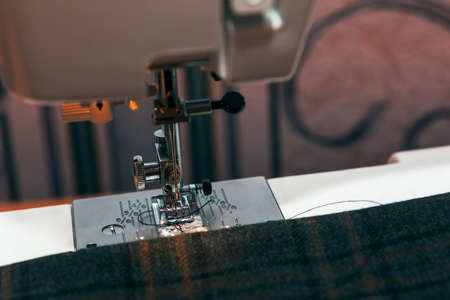 Sewing Machine with Material and Thread . Making clothes and dresses from fabric