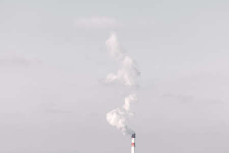 Polluted smoke from the pipe . Grey industrial smoke on the skyの写真素材