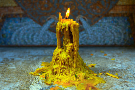 Candle with melting wax in the church . Place for prayingの写真素材