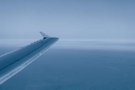 Aircraft wing in flight . View from flying plane