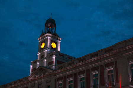 Horology at architecture tower . Clock Tower of Sun Gate in Madrid Spain . Real Casa de Correos at...