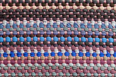 Braided rag with colored strings . Colorful pattern background