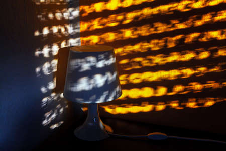 Lampshade in low light . Abstract light reflection in dark roomの写真素材