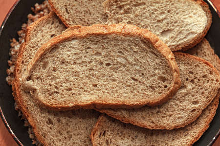 Bread with bran for dinner . Sliced bread
