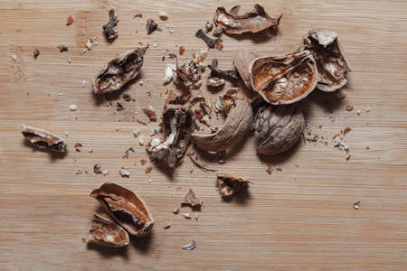 Shelled walnut . Peeled nut shell , wooden backgroundの写真素材