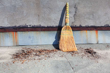 Broom and waste . Natural straw hand broom