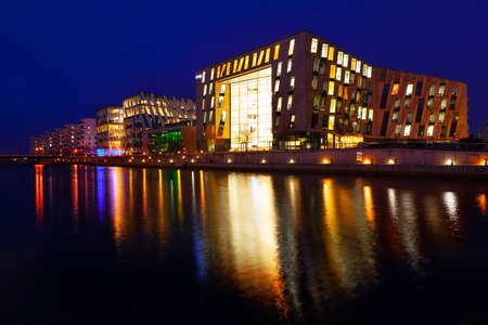 Copenhagen residential district and water canal in the nighttime . Modern buildings in the nightの写真素材