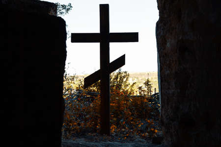 Cross silhouette . Wooden cross at cliff . Religious symbol