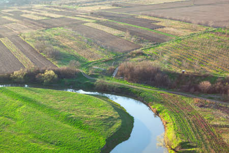 Green meadows and river . Countryside flowing waterの写真素材