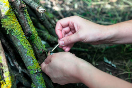 Matches in hands for fire burning . Picnic at nature
