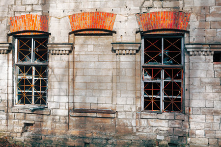 Brick wall and old windows . Abandoned house buildingの写真素材