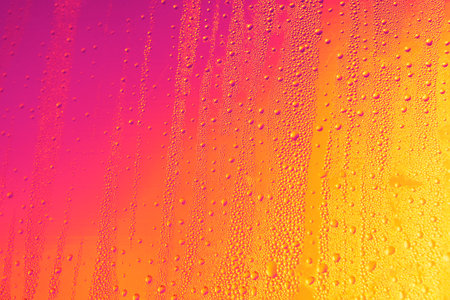 Water drops in colorful lights . Wet multicolor backgroundの写真素材