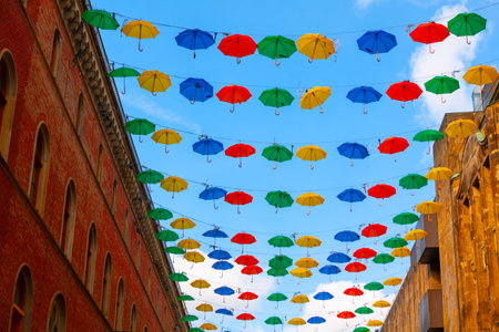 Hanging umbrellas over the street . Colorful umbrellas street decorの写真素材