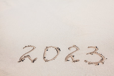 New Year 2023 on the sand . Handwritten in the sandの写真素材