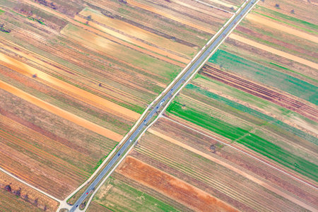 Aerial view of agriculture fields and highway . Arable land view from aboveの写真素材