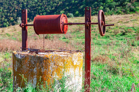 Old well with underground water . Groundwater source of water in the countrysideの写真素材