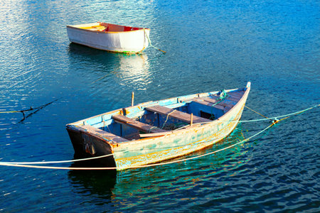 Wooden boats at blue water . Moored fishing boatsの写真素材