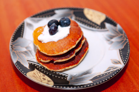 Pancakes with yogurt and berries. Homemade desert in the plateの写真素材
