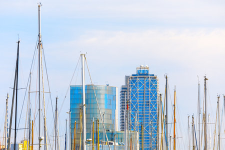 Yacht masts and skyscrapers . Modern harbor in the city