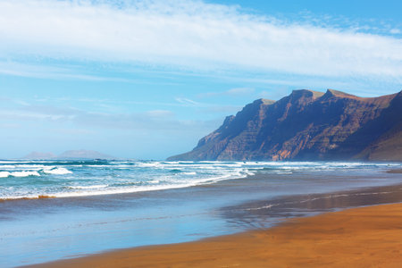 Beautiful Famara beach with spectacular cliffs in Lanzarote , Canary Islandsの写真素材