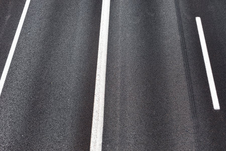 black asphalt with road marking backgroundの写真素材