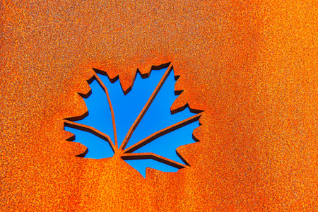 Metal autumn leaf . Carved leaf in rusty surfaceの写真素材