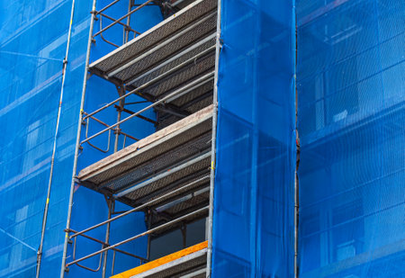 scaffolding on the facade of a skyscraper, closeup of photoの写真素材