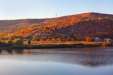 Autumn landscape with colorful trees on the bank of the river.