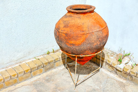 Ancient amphora, a type of ceramic vessel typically used in antiquity for storing and transporting...