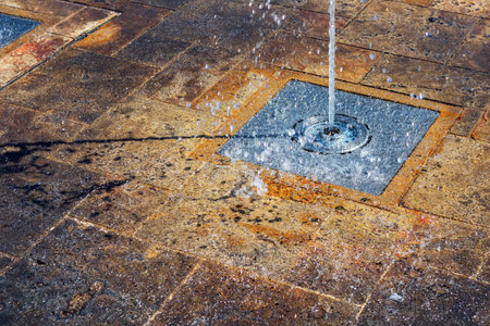 Fountain in the city center of Lisbon, Portugal. Water flows into the fountain.の写真素材