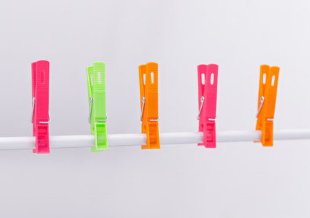 Colorful clothespins on a clothesline isolated on a white backgroundの写真素材