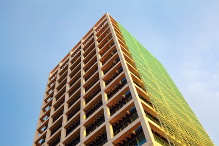 High rise building with blue sky and cloud background, closeup of photo