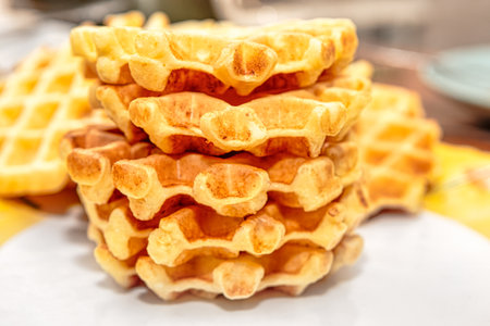 Stack of Venetian waffles. Piled delicious waffles enjoyed for breakfastの写真素材