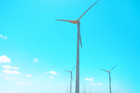 Wind turbines against blue sky. Renewable energy solution harnessing wind power to generate electricity offshoreの写真素材