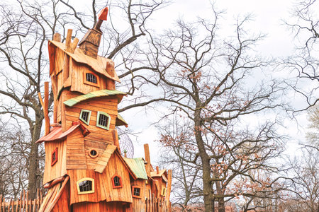 Wooden fairy-tale house in the park on a cloudy dayの写真素材