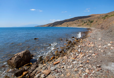 Empty beach with coastal rocks  . Stones on the water's edge