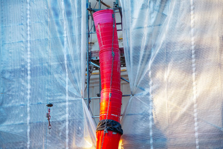 Waste material chutes on construction site. Shot of a conveyor of rubble in the building under...