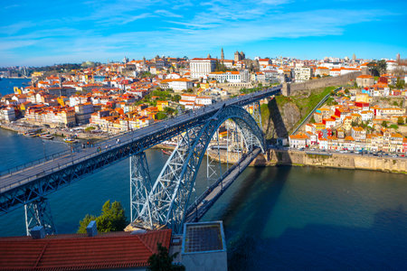The Dom Luis I Bridge spans the Douro River in Porto, Portugal, connecting historic cityscape with...