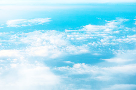 High altitude view of cumulus clouds against a vibrant azure backdrop. aerial soft white clouds...