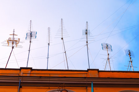 Vintage television antennas on the rooftop. Multiple antennas, a visual representation of the many signals reaching the buildingの写真素材