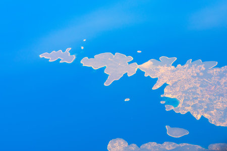 Aerial view of small islands and peninsulas in Croatia surrounded by blue sea, intricate coastlines...