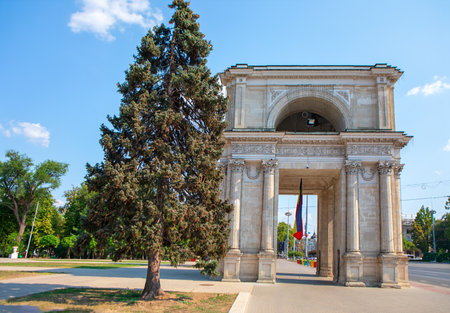 Chisinau Triumphal Arch in the city center, near central park. Neoclassical design and national flag evoke Moldova historic pride and architectural eleganceの写真素材