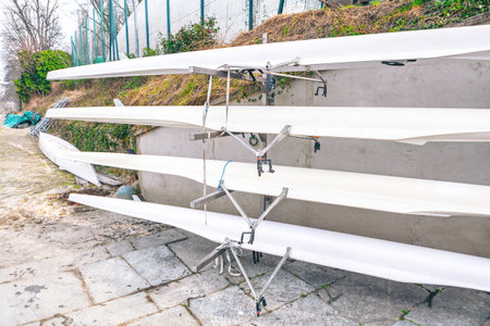 Rack holds several racing shells, known as fine boats. These long, narrow boats are designed for...