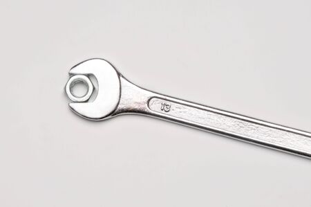 seen from above a spanner and nut on white backgroundの写真素材